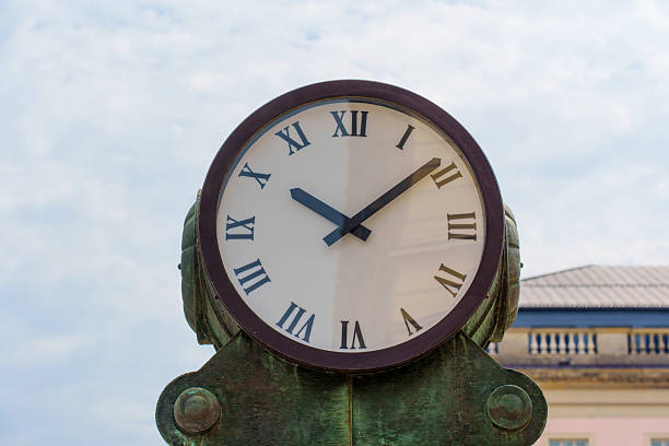 Berlin, Germany - June 1, 2025: Historic clock at Bebelplatz features Roman numerals and brass detailing. Clear sky backdrop highlights the intricate craftsmanship of this iconic Berlin landmark.
