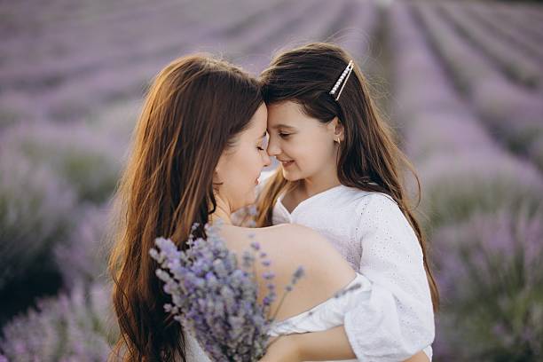 istock Mother and daughter embracing in a lavender field 2226100772