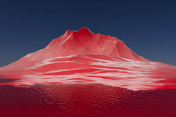 A mountain with a red top and a blue sky. The mountain is in the distance