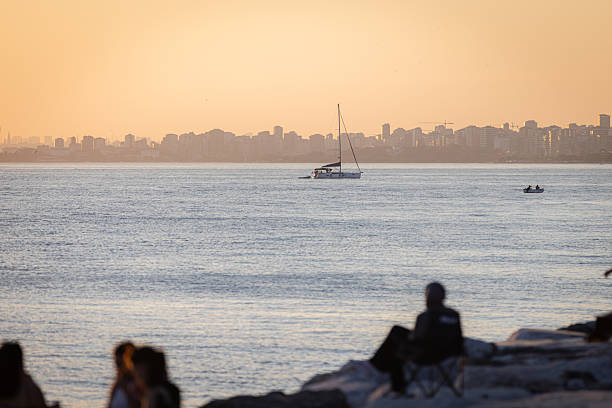 istock People silhouettes with seascape at sunset. 2226102183
