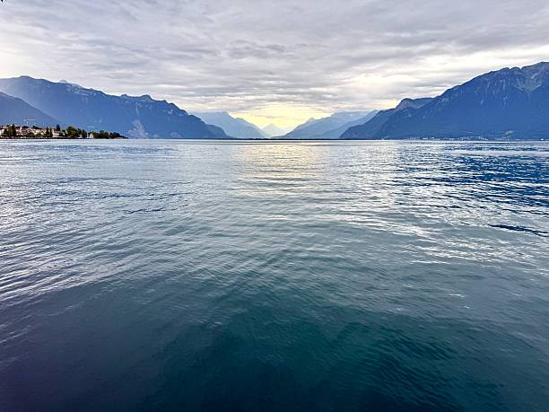 Wide-angle view of Lake Geneva near Villeneuve, vast water surface and distant Alps mountain