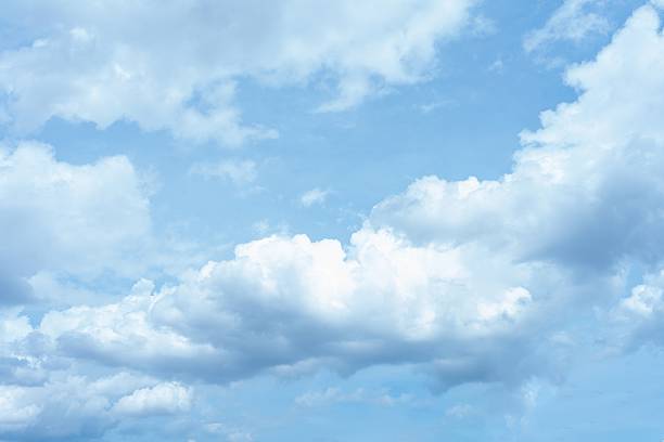 High resolution image of a bright blue sky filled with fluffy white cumulus clouds Perfect for backgrounds