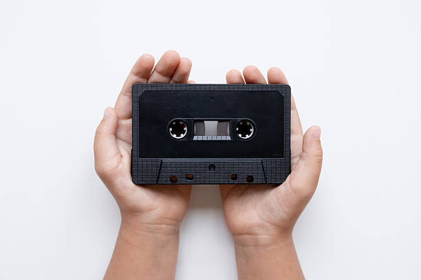 istock Child hands holding black audio cassette on white background 2226109968