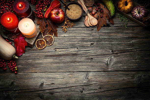 istock Autumn or Thanksgiving border. Decor with burning candles, fallen leaves, nuts, cinnamon sticks and pumpkin. Greeting card or copy space. October or season. Happy Thanksgiving 2226110565