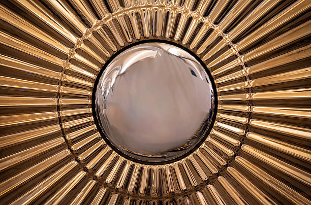 Radiant golden sunburst wall mirror with a convex reflective center