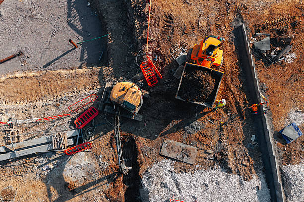 istock Aerial view from drone at excavator and dumper busy at construction site 2226112120