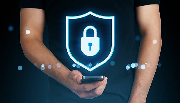 istock Man holding smartphone with glowing holographic padlock shield symbolizing cybersecurity, privacy, and data protection in modern digital world. 2226112503