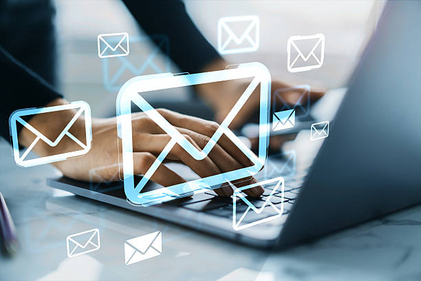 istock Hands typing on laptop with floating digital email icons symbolizing online communication and cloud-based messaging services in business context. 2226112527