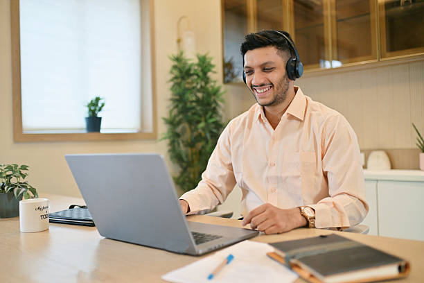 istock Young Man Smiling During a Video Call on His Laptop from home 2226114162