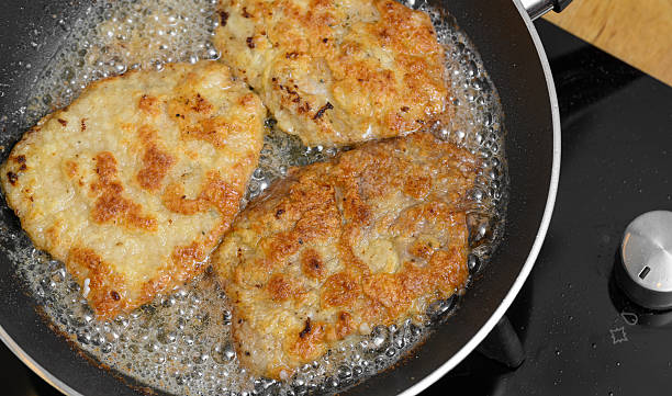 istock Pork chops frying in oil in a pan 2226117591