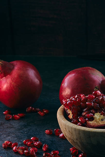 istock red ripe pomegranate fruits on dark background 2226120667