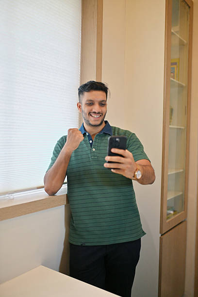 istock Man Celebrating Good News While Checking His Phone 2226120821
