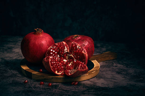 istock juicy pomegranate on a dark background 2226120919