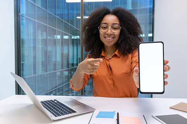 istock Happy woman presenting a smartphone with a blank white screen. 2226124566