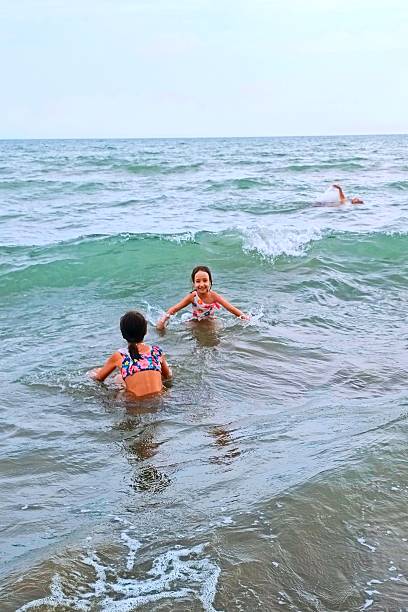 istock Kids are having fun by jumping on the waves 2226125290