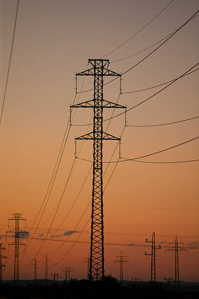 istock Power lines silhouetted against a colorful sunset sky 2226125308