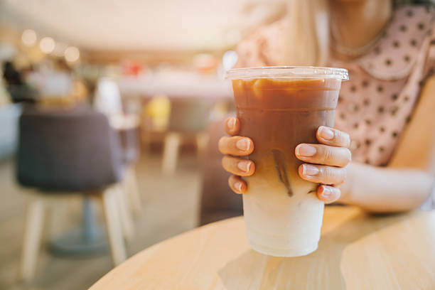 istock Iced coffee drink held by a person in a cafe setting 2226130096