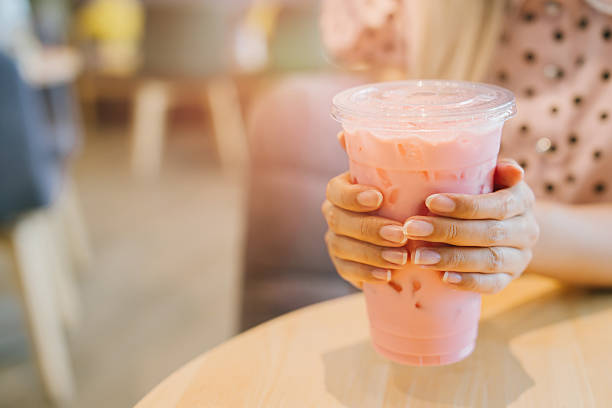 istock Refreshing Pink Beverage in Clear Cup on Wooden Table 2226130105