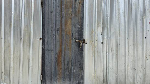 istock The old silver zinc wall and door have rust stains. 2226132768