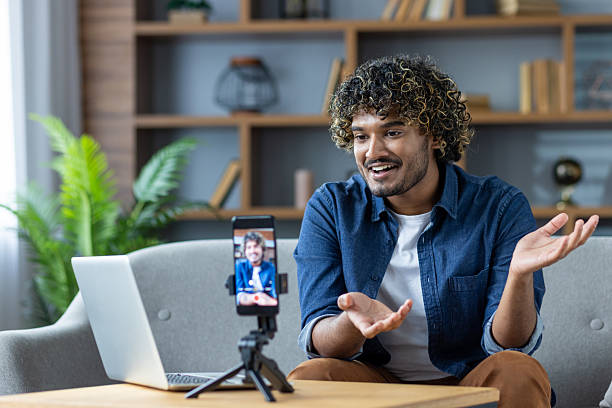 istock Happy young man on a video call, smiling and gesturing at home 2226132793