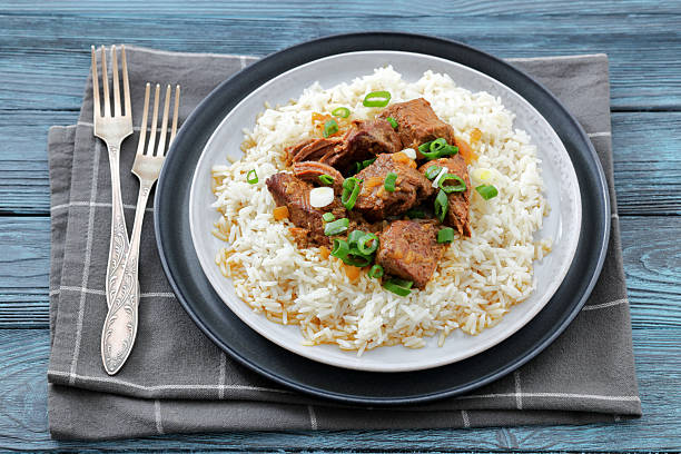 istock beef slow cooked with gravy served over rice 2226134751