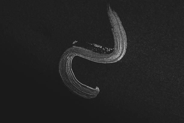 istock Light brush stroke on black paper as artistic paint trace with texture isolated on dark background for backdrop or design 2226138152