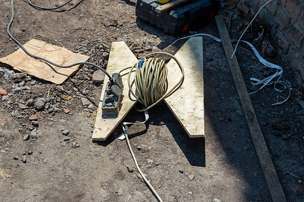 istock Power strip and coiled extension cord rest on a makeshift wooden stand at a construction site, highlighting the preparation for electrical work 2226138936