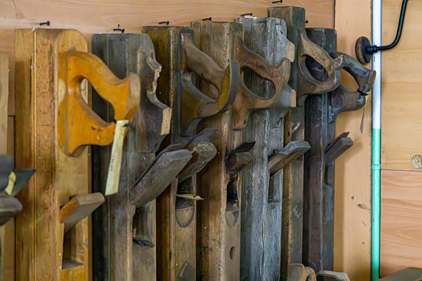 Vintage wooden hand planes hanging on a workshop wall.
