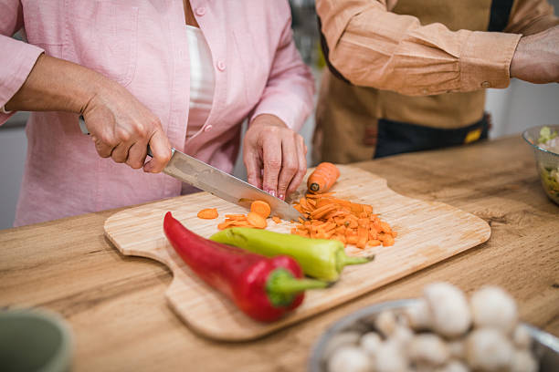 istock Close-up of a woman's hands cutting vegetables on a cutting board 2226148487
