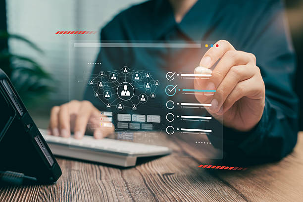 istock Digital human resources management concept. Hand interacting with virtual network diagram and employee performance checklist. 2226149332