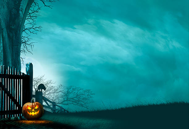 Jack O'lantern Sitting At Base Of Old Gate