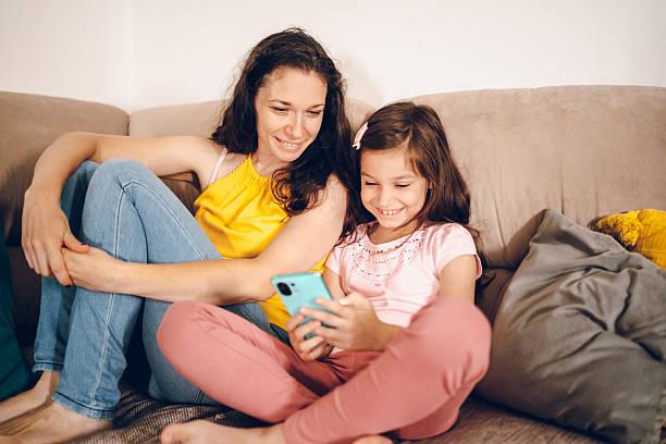 istock Happy mom and daughter using phone 2226150670