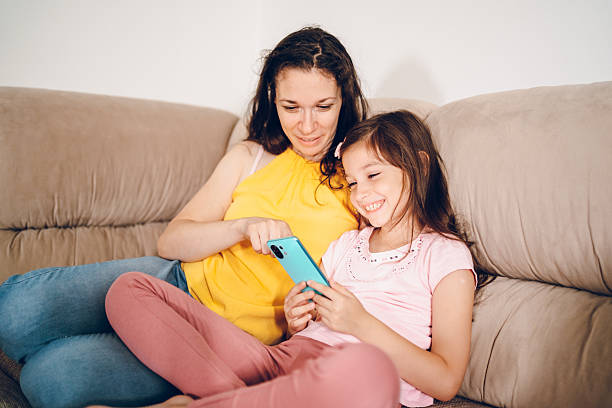 istock Happy mom and daughter using phone 2226150690