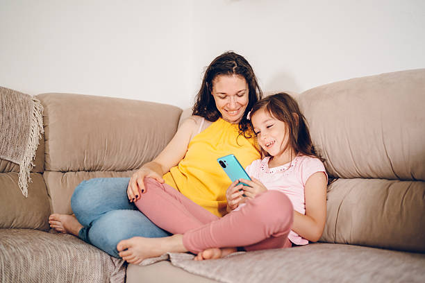 istock Happy mom and daughter using phone 2226151129