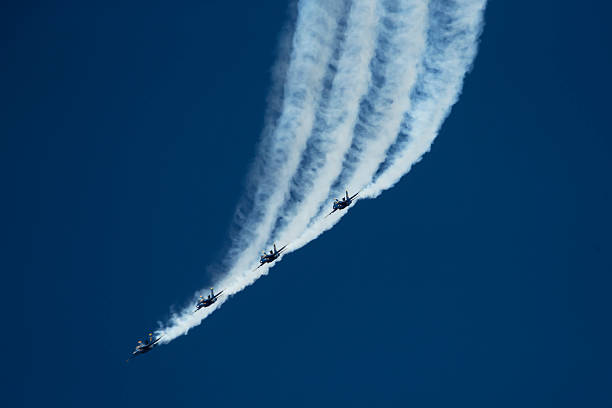 The Blue Angels, also referred to as the U.S. Navy Flight Demonstration Squadron, four Boeing FA-18 Super Hornets having just performed a loop against a clear blue sky at an air show at the Naval Air Facility,  El Centro, California.  Photography date: March 16, 2019.