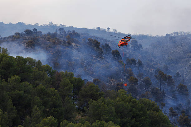 istock An unrecognizable helicopter with a Bambi bucket approaches the fire 2226163340