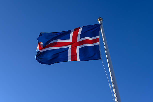 istock Icelandic flag waving in the wind on a blue sky 2226164525
