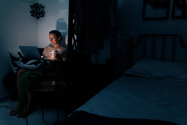 istock Woman relaxing at home at night doing online shopping using laptop computer 2226165152