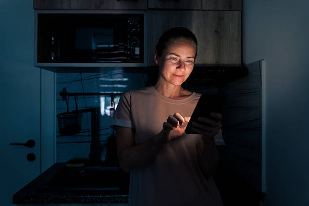 istock Woman scrolling using smart phone while relaxing at home at night 2226165451