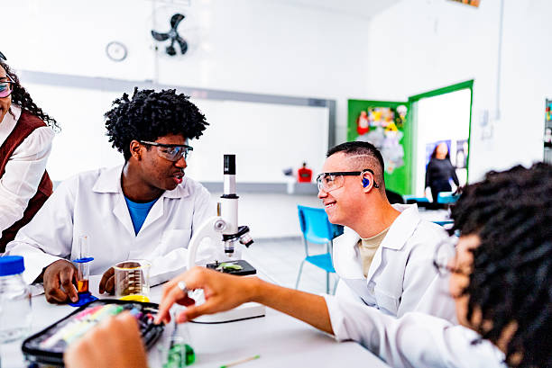 Students conducting chemistry experiment in school laboratory - including people with Down syndrome