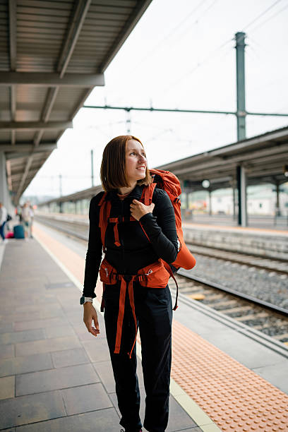 istock Young woman backpacker waiting at train station 2226168899