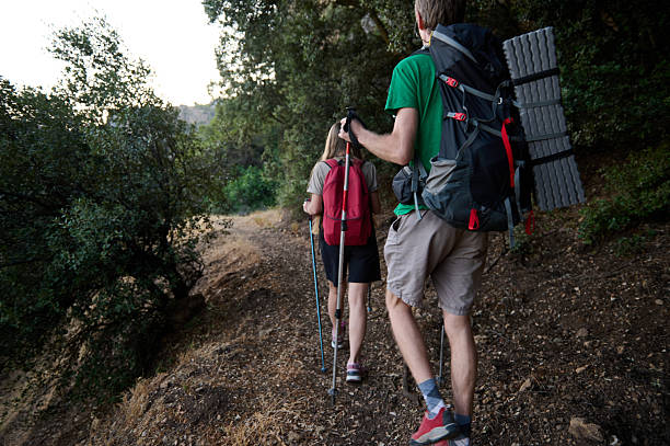 istock Hikers Exploring a Scenic Trail in a Forested Hillside with Backpacks 2226168950