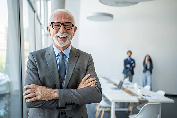 istock Smiling senior businessman posing in modern office with folded arms 2226169340
