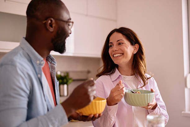 istock Happy couple eating breakfast and talking in the kitchen 2226173460
