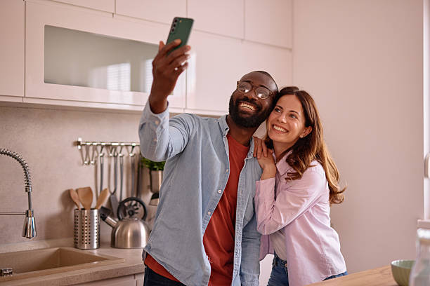 istock Happy couple taking a selfie in their modern kitchen 2226173477