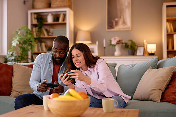 istock Couple playing video games at home on the sofa 2226173568