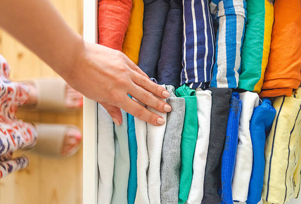 istock Woman choosing clothes from organized drawer with folded T-shirts 2226174537