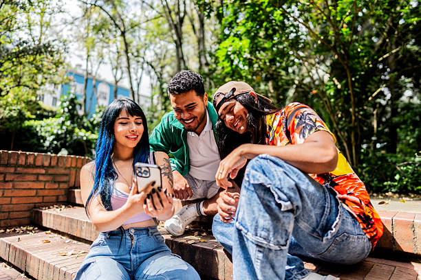 istock Young friends using mobile phone outdoors 2226174866