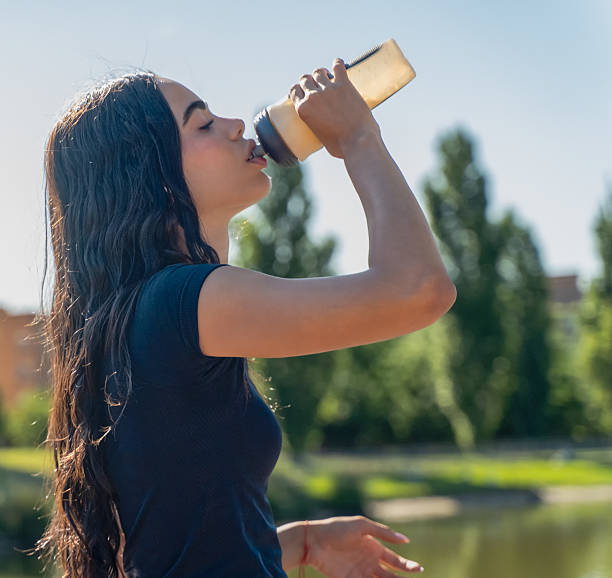 istock Teenager drinking water after training, refreshing on a sunny day 2226176523