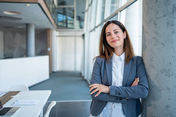 istock Confident businesswoman smiling with folded arms in modern office 2226176751